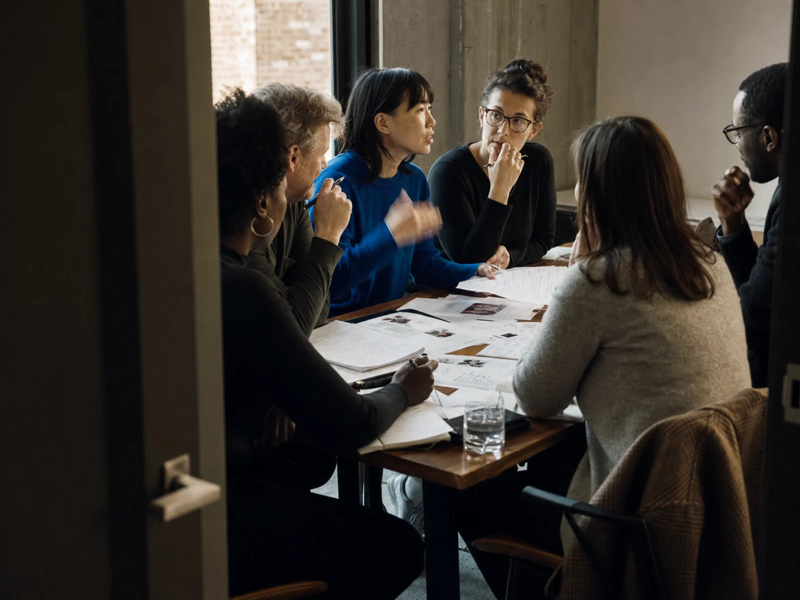 A recruiting team reviewing candidates and making hiring decisions together.